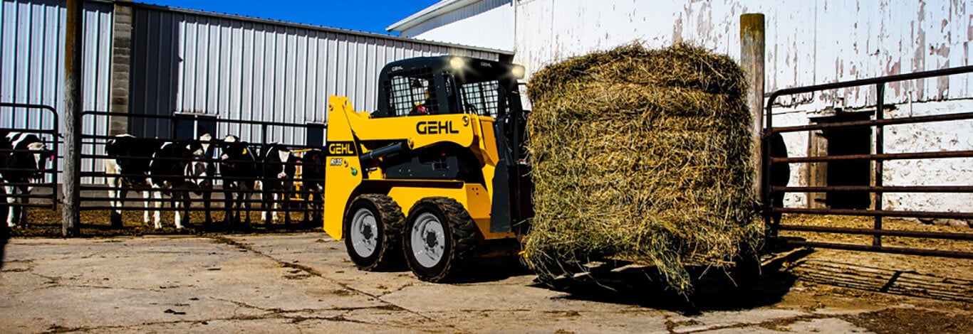Gehl Loader Moving Round Bale